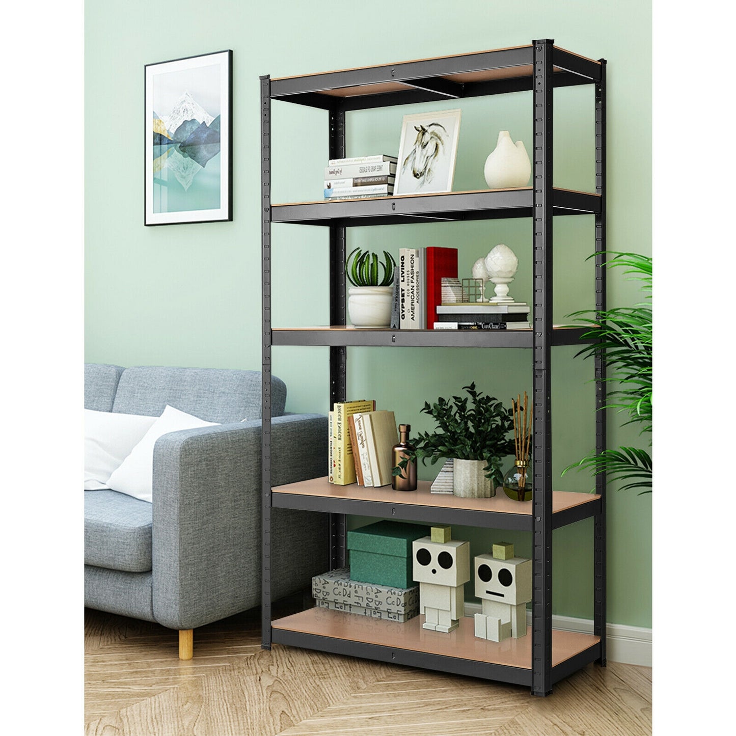 A 5-tier metal and wood shelving unit with black metal frames and brown wooden shelves, placed in a room with a gray sofa, decorative items, and a green plant.
