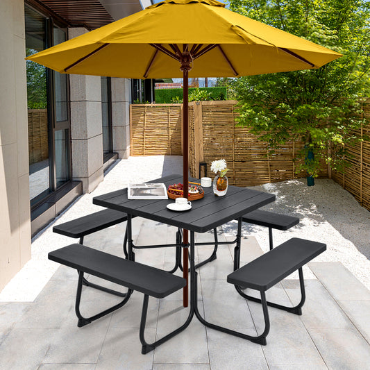 Outdoor picnic table with four built-in benches and an umbrella hole, set on a tiled floor under a yellow umbrella, with a pair of benches placed on either side of the table.
