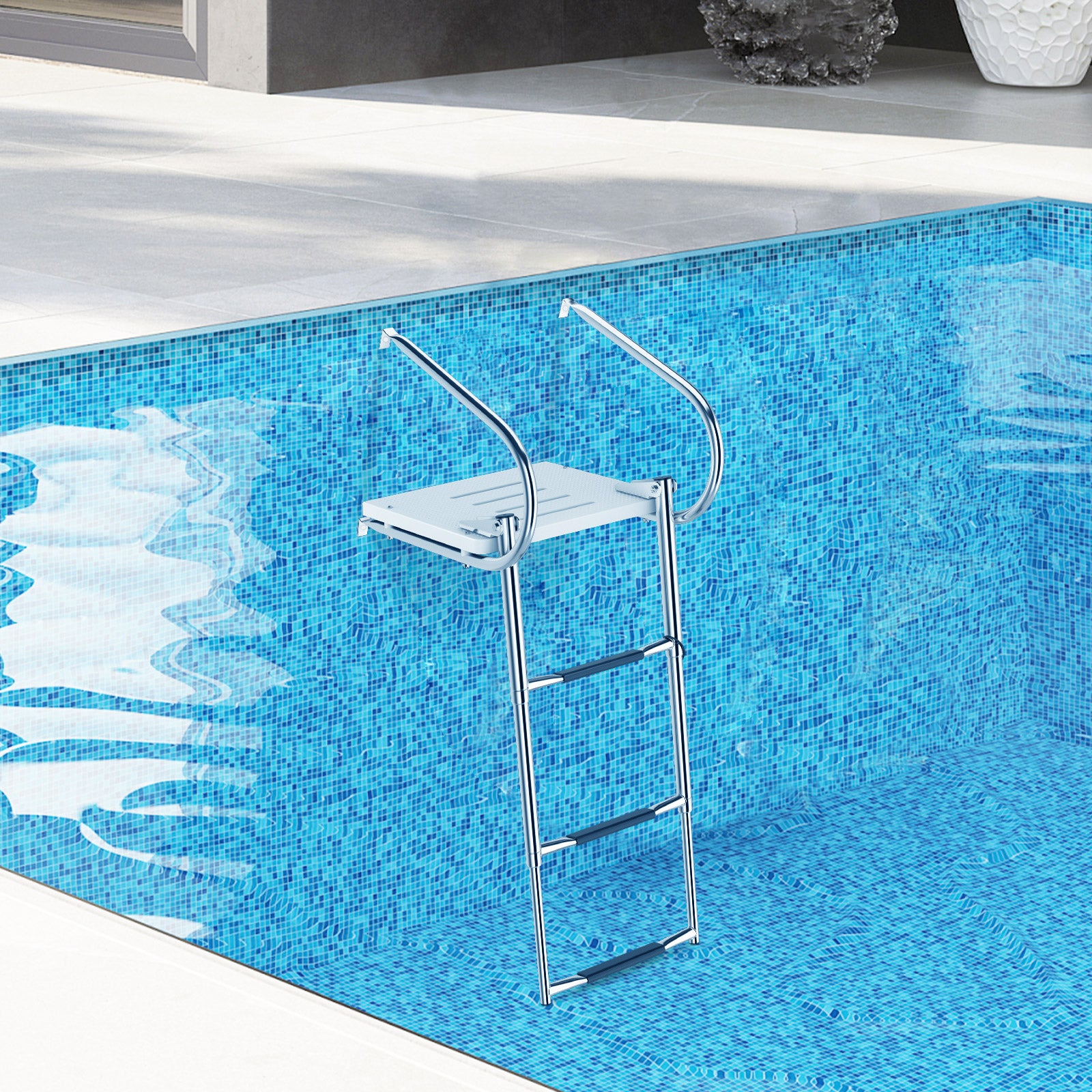 A silver telescoping boat ladder with a fiberglass platform and handrails is extended into a pool, illustrating its use for accessing watercraft or pools.