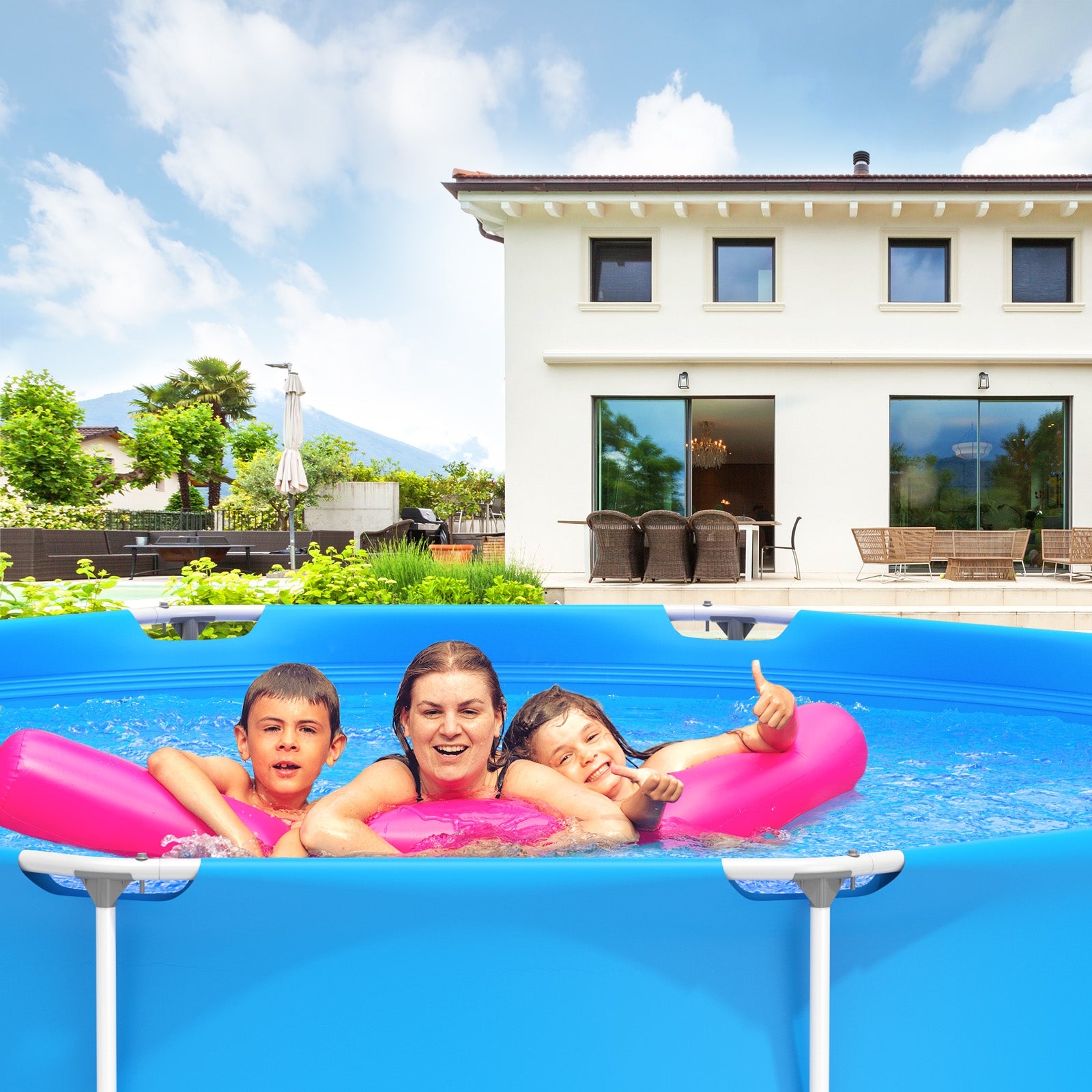 A family enjoying in a round above-ground swimming pool with blue water, in front of a house with a patio and greenery in the background.