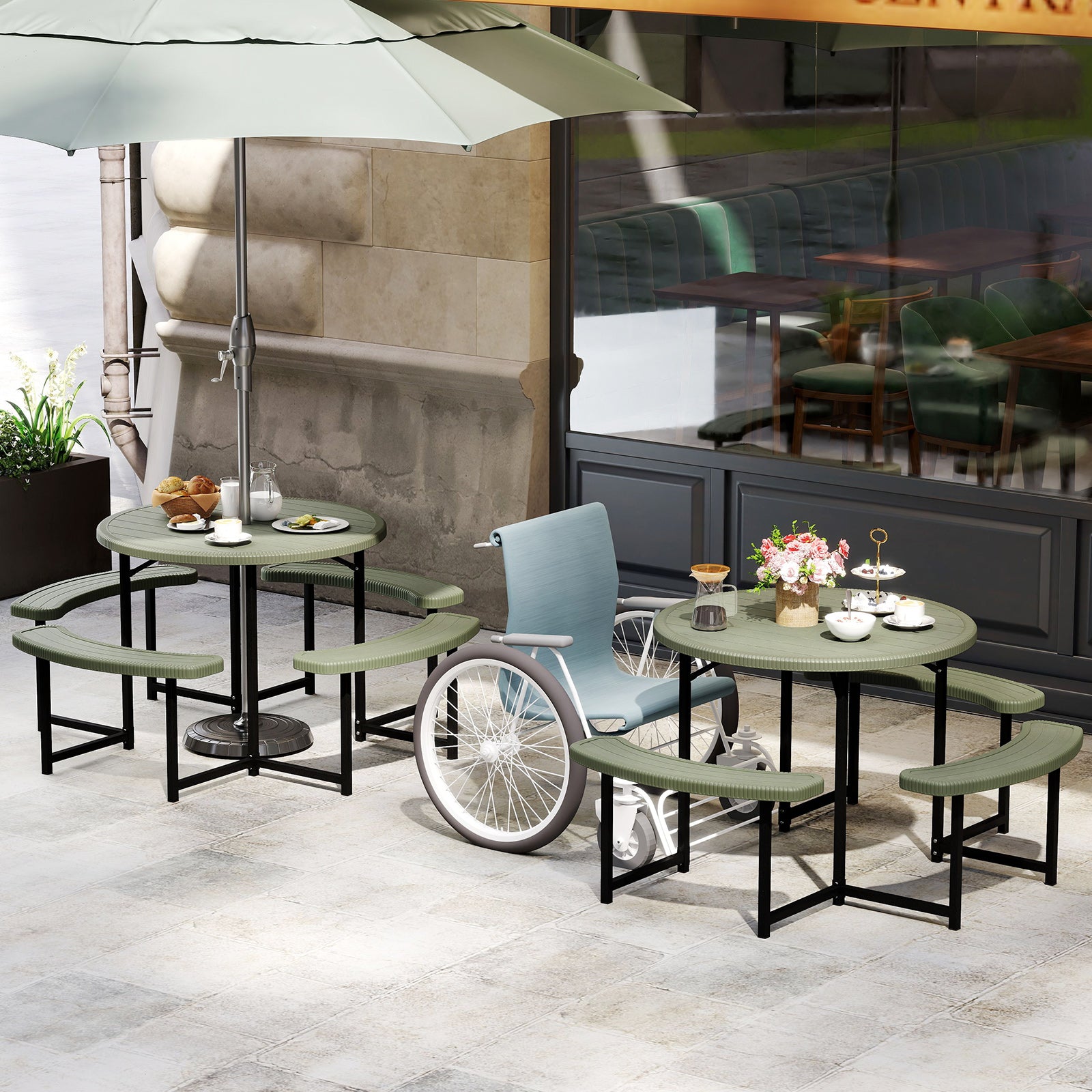 A round picnic table with a HDPE tabletop and black metal legs, accompanied by four  curved benches with a faux shell texture. The set is placed on a wooden deck with outdoor seating and a small umbrella in the background.